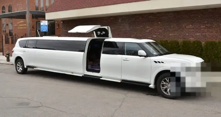 White Infiniti QX80 stretch SUV limousine